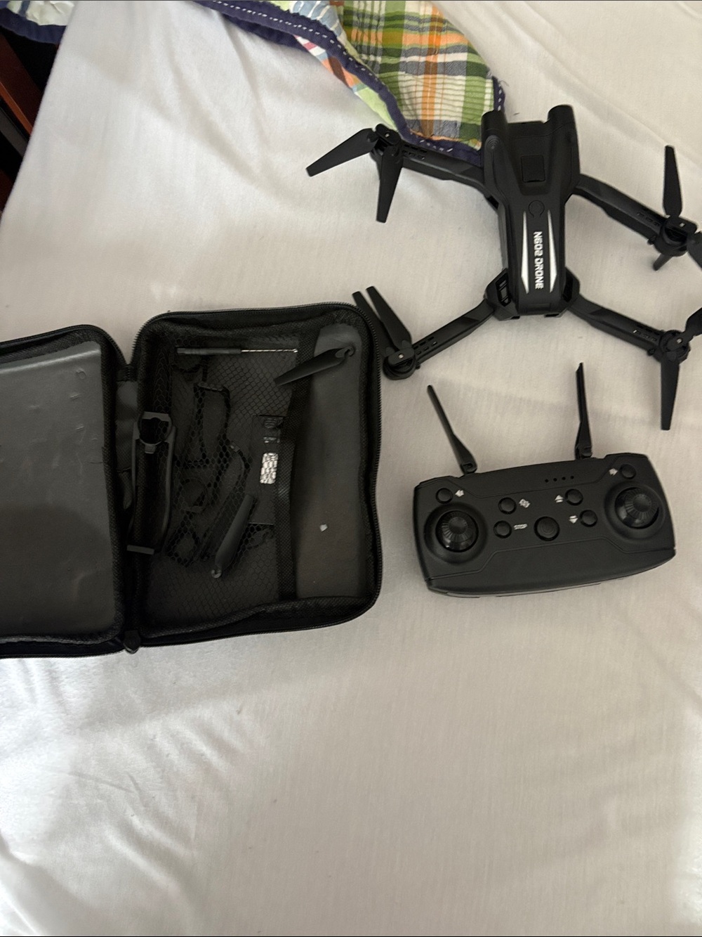 All black drone with controller and carrying case